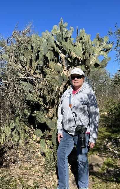 standing in front of cactus